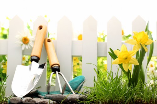 Brentford gardener handling tools and materials safely during work